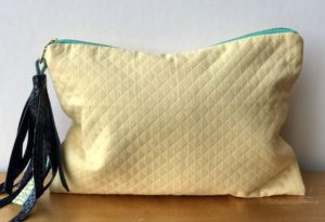 EVA TASSELED CLUTCH POUCH IN QUILTED BUTTER YELLOW COTTON
